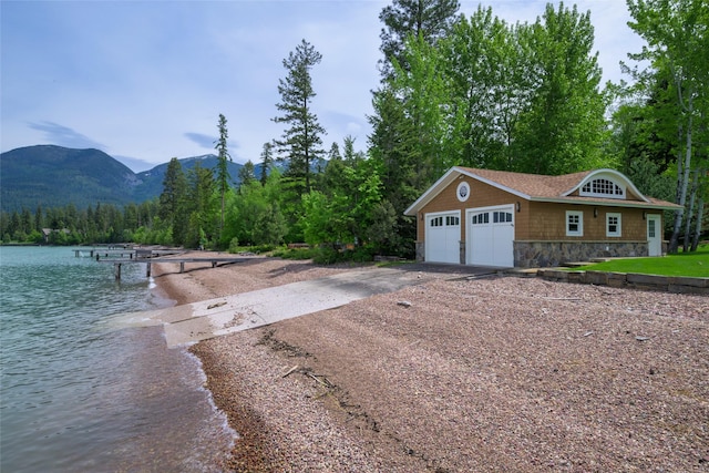 33702 N Finley Point Rd, Polson, MT 59860 - exterior space featuring driveway, a water and mountain view, and a forest view