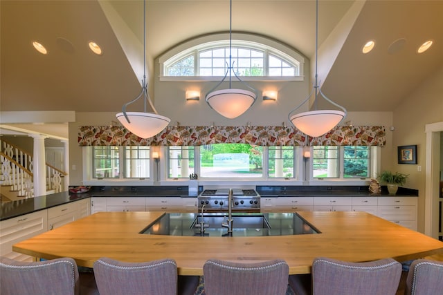 33702 N Finley Point Rd, Polson, MT 59860 - dining space with high vaulted ceiling, stairs, recessed lighting, and decorative columns