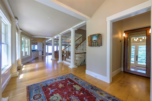 33702 N Finley Point Rd, Polson, MT 59860 - hallway with decorative columns, baseboards, wood finished floors, and stairway
