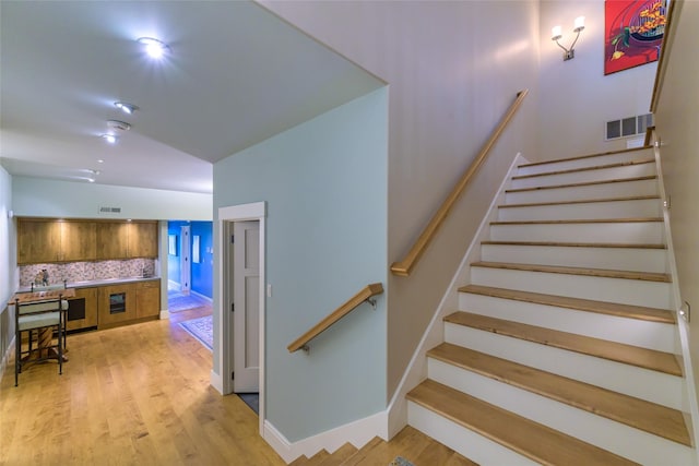 33702 N Finley Point Rd, Polson, MT 59860 - stairway featuring vaulted ceiling, wood finished floors, and baseboards