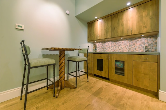 33702 N Finley Point Rd, Polson, MT 59860 - kitchen featuring backsplash, light wood-type flooring, stainless steel counters, a breakfast bar area, and recessed lighting