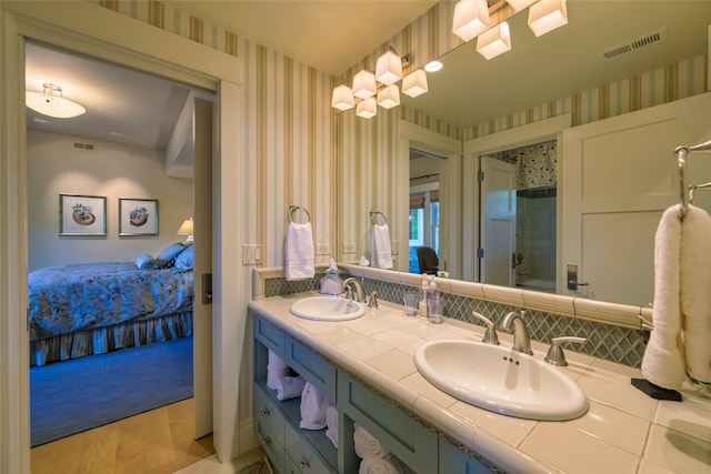 33702 N Finley Point Rd, Polson, MT 59860 - bathroom with wallpapered walls, double vanity, a shower, and backsplash