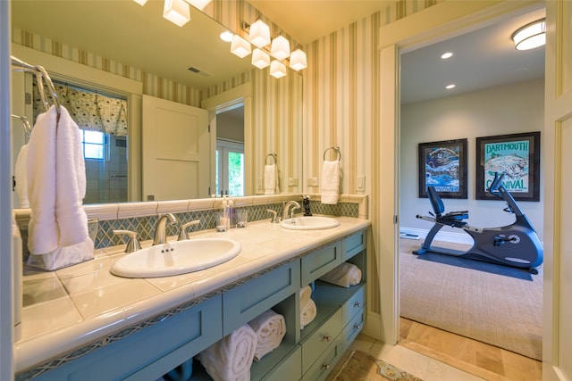 33702 N Finley Point Rd, Polson, MT 59860 - bathroom with wallpapered walls, double vanity, a garden tub, tasteful backsplash, and healthy amount of natural light