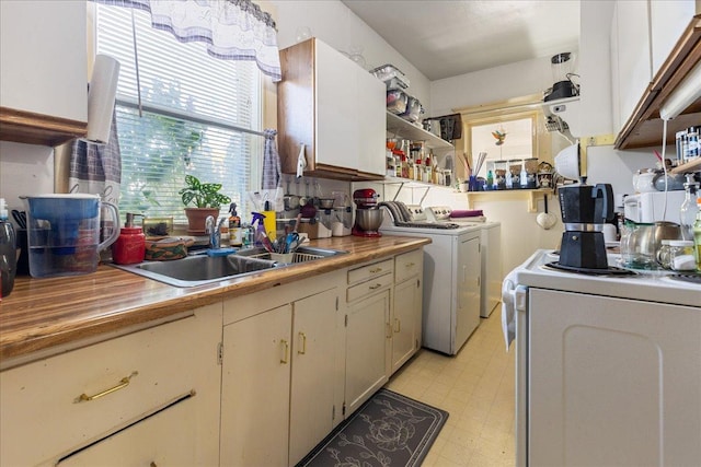 375 N Main St, Kalispell, MT 59901 - kitchen featuring a sink, washer and dryer, light floors, open shelves, and light countertops