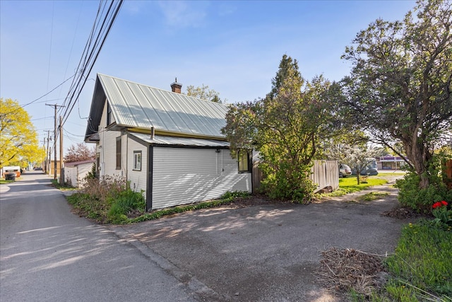 375 N Main St, Kalispell, MT 59901 - view of home's exterior featuring a chimney and metal roof
