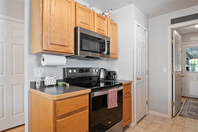 409 Bentley Park Loop, Missoula, MT 59801 - kitchen with stainless steel appliances and dark countertops