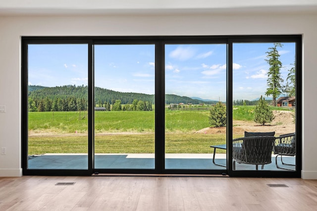 165 River Ranch Rd, Whitefish, MT 59937 - doorway to outside with plenty of natural light, a mountain view, wood finished floors, and baseboards