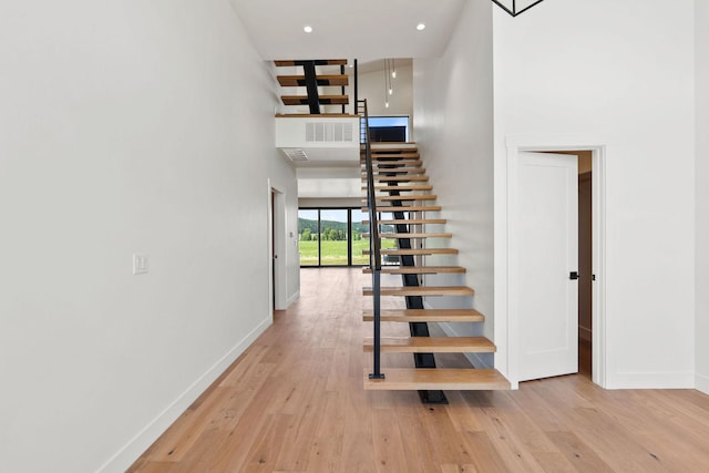 165 River Ranch Rd, Whitefish, MT 59937 - stairs featuring a high ceiling, baseboards, and hardwood / wood-style floors