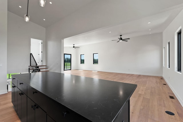 165 River Ranch Rd, Whitefish, MT 59937 - kitchen with dark cabinetry, a ceiling fan, light wood-style floors, recessed lighting, and a high ceiling