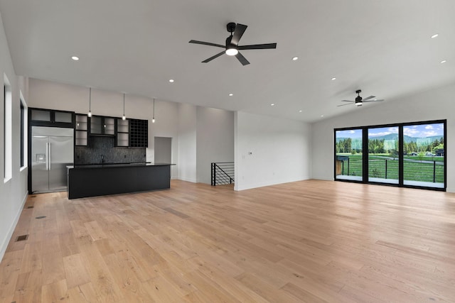 165 River Ranch Rd, Whitefish, MT 59937 - unfurnished living room with a ceiling fan, light wood-type flooring, recessed lighting, baseboards, and lofted ceiling