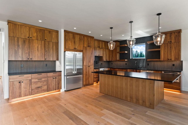 165 River Ranch Rd, Whitefish, MT 59937 - kitchen with stainless steel built in refrigerator, open shelves, dark countertops, brown cabinets, and recessed lighting