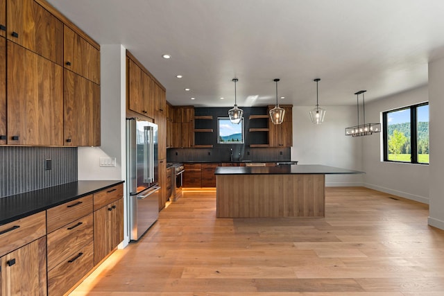 165 River Ranch Rd, Whitefish, MT 59937 - kitchen with high end appliances, open shelves, dark countertops, a center island, and recessed lighting