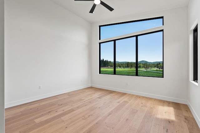 165 River Ranch Rd, Whitefish, MT 59937 - unfurnished room featuring a mountain view, light wood-type flooring, baseboards, and ceiling fan