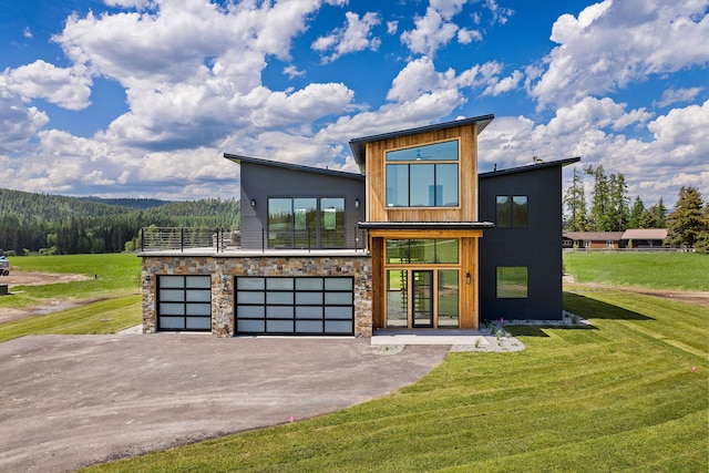165 River Ranch Rd, Whitefish, MT 59937 - modern home with a front yard, driveway, and a garage