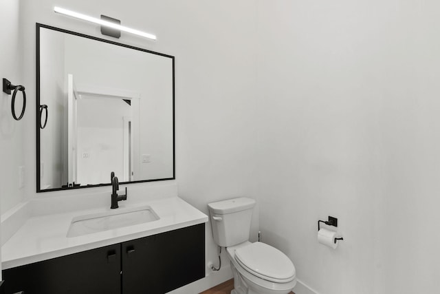 165 River Ranch Rd, Whitefish, MT 59937 - half bathroom featuring toilet, vanity, and baseboards