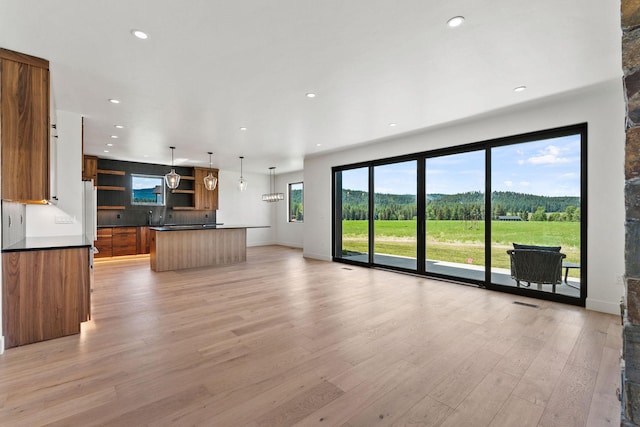 165 River Ranch Rd, Whitefish, MT 59937 - unfurnished living room with light wood-style floors, recessed lighting, and baseboards