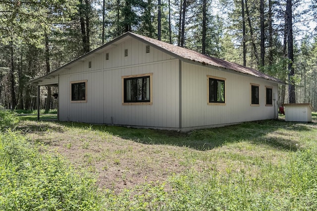 785 La Brant Rd, Bigfork, MT 59911 - view of property exterior with a yard, a storage shed, and a metal roof