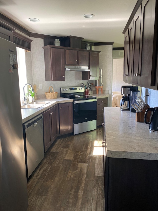 1045 Conrad Dr Unit 114, Kalispell, MT 59901 - kitchen featuring stainless steel appliances, a sink, under cabinet range hood, dark wood-style flooring, and light countertops