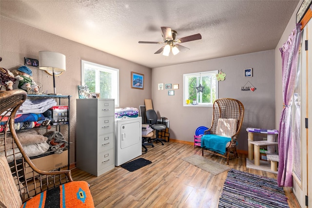 1319 3rd St, Whitefish, MT 59937 - office area with washer / dryer, wood finished floors, plenty of natural light, a ceiling fan, and a textured ceiling