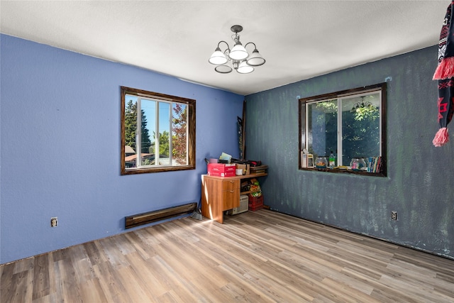 1319 3rd St, Whitefish, MT 59937 - empty room with plenty of natural light, a chandelier, and wood finished floors