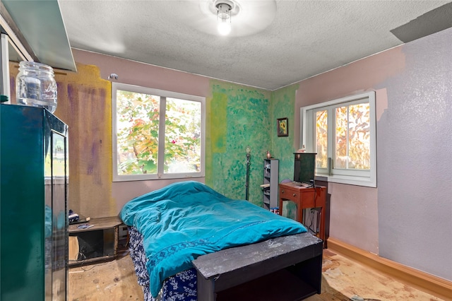1319 3rd St, Whitefish, MT 59937 - bedroom featuring a textured ceiling, wood finished floors, and baseboards
