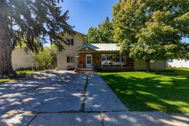 1319 3rd St, Whitefish, MT 59937 - view of front facade with a front lawn, a chimney, and driveway