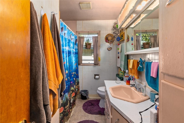 1319 3rd St, Whitefish, MT 59937 - bathroom featuring vanity, tile patterned floors, tile walls, toilet, and a shower with curtain