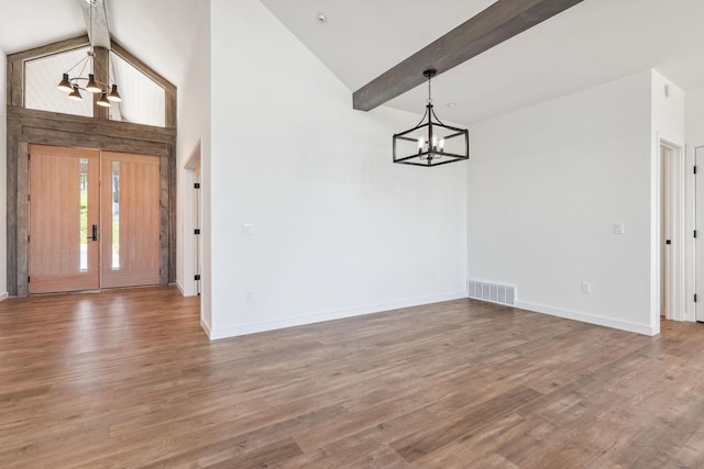148 Blacktail Loop, Lakeside, MT 59922 - unfurnished dining area with a chandelier, baseboards, high vaulted ceiling, wood finished floors, and beam ceiling