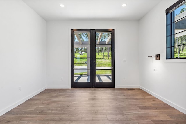 148 Blacktail Loop, Lakeside, MT 59922 - empty room with wood finished floors, recessed lighting, baseboards, and french doors