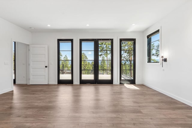 148 Blacktail Loop, Lakeside, MT 59922 - doorway with baseboards, wood finished floors, recessed lighting, and french doors