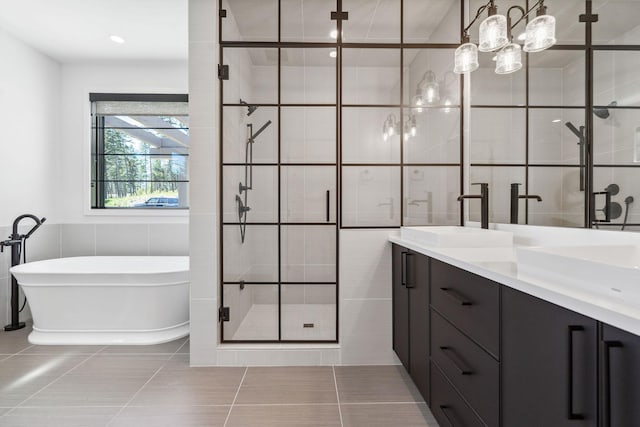 148 Blacktail Loop, Lakeside, MT 59922 - full bath featuring tile walls, a stall shower, a freestanding tub, double vanity, and tile patterned floors