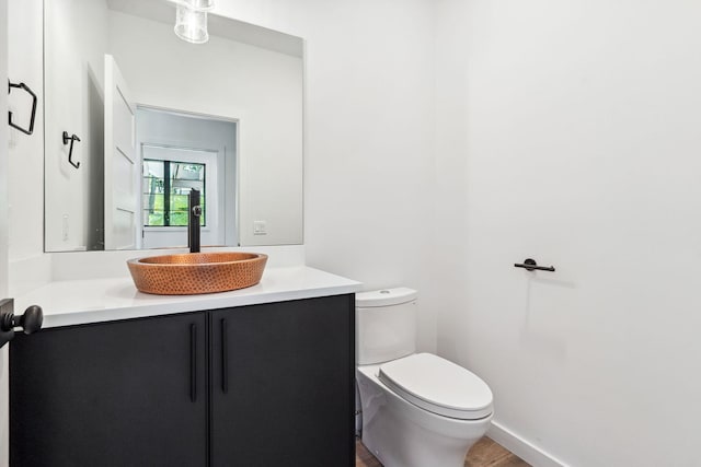 148 Blacktail Loop, Lakeside, MT 59922 - half bath featuring vanity, toilet, and wood finished floors