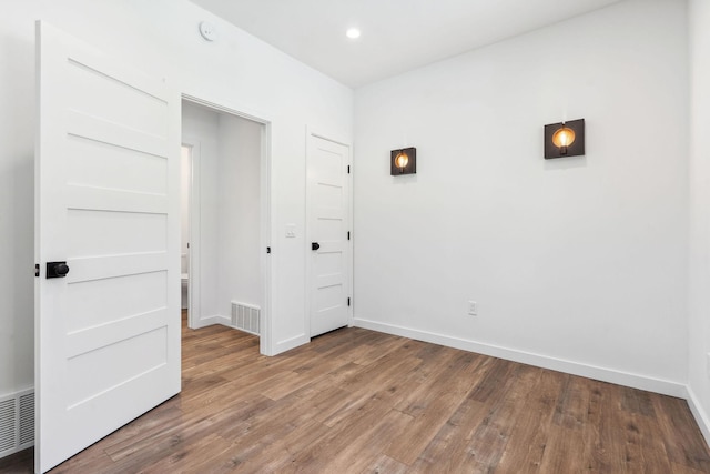 148 Blacktail Loop, Lakeside, MT 59922 - unfurnished bedroom with wood finished floors, baseboards, and recessed lighting
