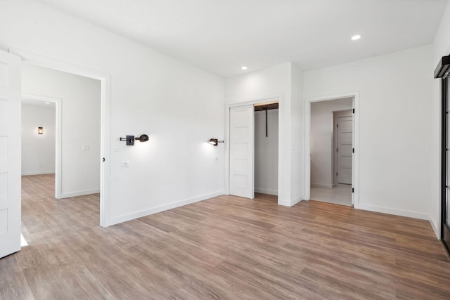 148 Blacktail Loop, Lakeside, MT 59922 - unfurnished bedroom featuring light wood-style floors, baseboards, and recessed lighting