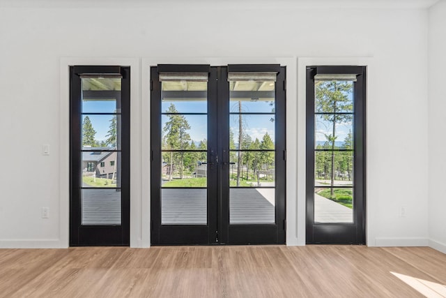 148 Blacktail Loop, Lakeside, MT 59922 - doorway with baseboards, french doors, and wood finished floors
