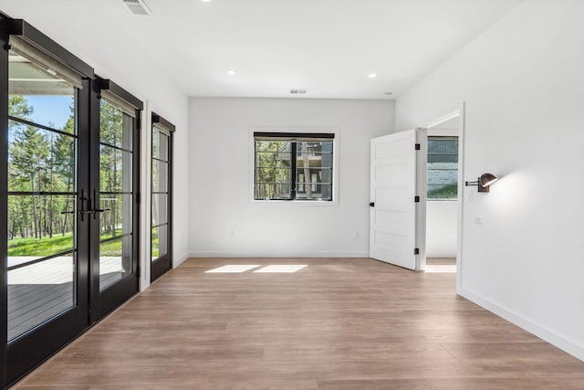 148 Blacktail Loop, Lakeside, MT 59922 - spare room featuring healthy amount of natural light, french doors, wood finished floors, and recessed lighting