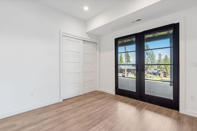 148 Blacktail Loop, Lakeside, MT 59922 - unfurnished bedroom with french doors, light wood-style flooring, baseboards, access to exterior, and recessed lighting