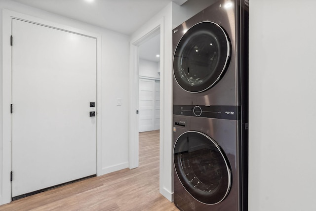 148 Blacktail Loop, Lakeside, MT 59922 - laundry area with estacked washer and dryer, light wood-type flooring, and baseboards