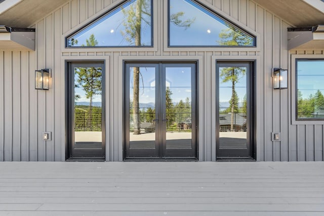 148 Blacktail Loop, Lakeside, MT 59922 - doorway to property featuring french doors, a wooden deck, and board and batten siding