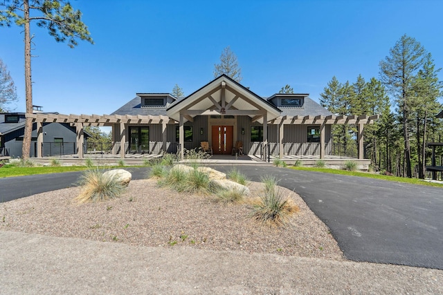 148 Blacktail Loop, Lakeside, MT 59922 - view of front of house with board and batten siding, french doors, and a pergola