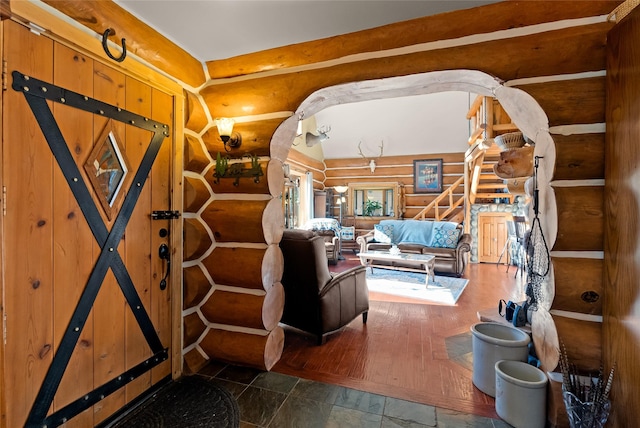 2700 Lyon Creek Rd, Missoula, MT 59804 - living area with log walls, stairway, and stone finish flooring