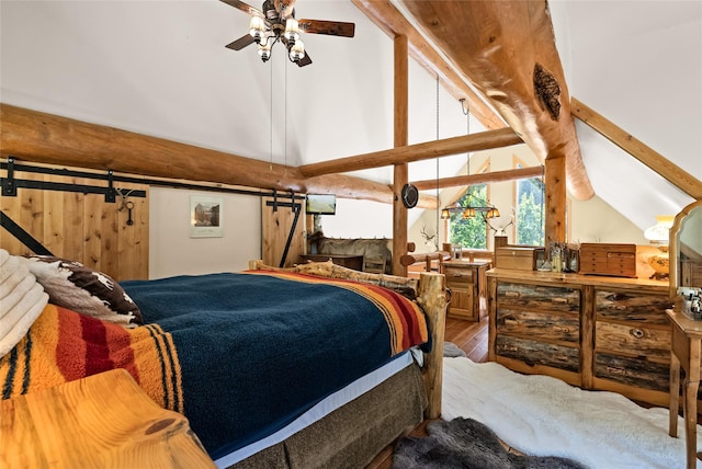 2700 Lyon Creek Rd, Missoula, MT 59804 - bedroom with a barn door and wood finished floors