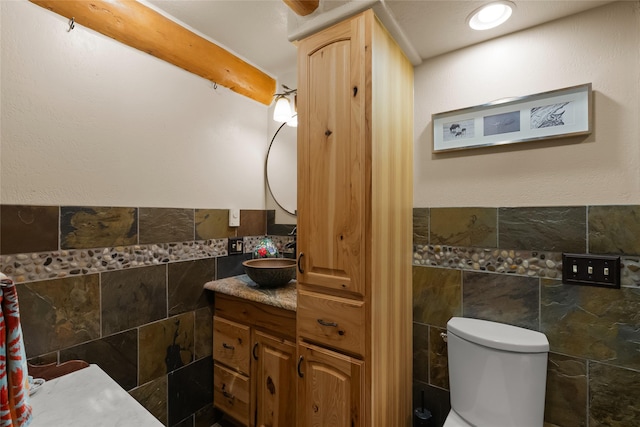 2700 Lyon Creek Rd, Missoula, MT 59804 - bathroom featuring tile walls, vanity, and a wainscoted wall