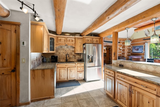 2700 Lyon Creek Rd, Missoula, MT 59804 - kitchen featuring stainless steel fridge with ice dispenser, decorative backsplash, stone countertops, light tile patterned flooring, and beam ceiling