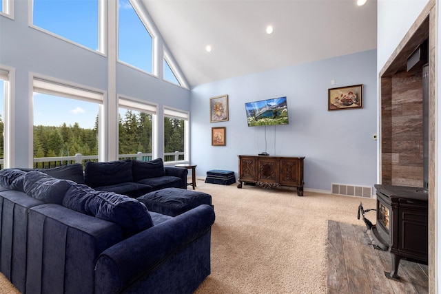 115 Wagon Wheel Rd, Whitefish, MT 59937 - carpeted living area featuring high vaulted ceiling, a wood stove, and recessed lighting