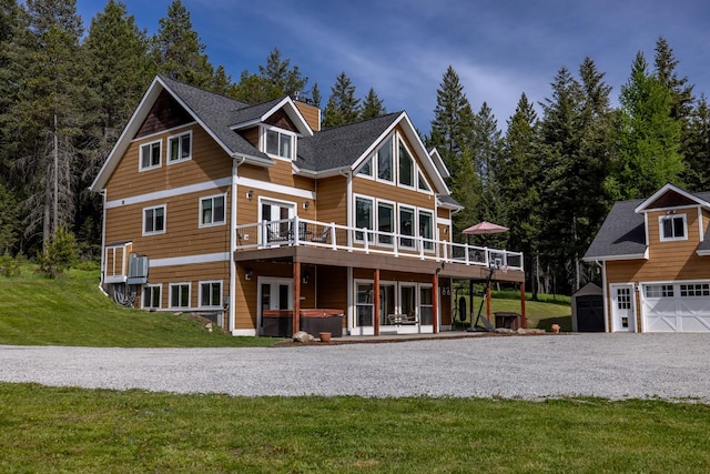 115 Wagon Wheel Rd, Whitefish, MT 59937 - back of property with a hot tub, a wooden deck, a yard, and a shed