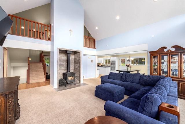 115 Wagon Wheel Rd, Whitefish, MT 59937 - living area featuring carpet floors, stairs, high vaulted ceiling, a wood stove, and recessed lighting