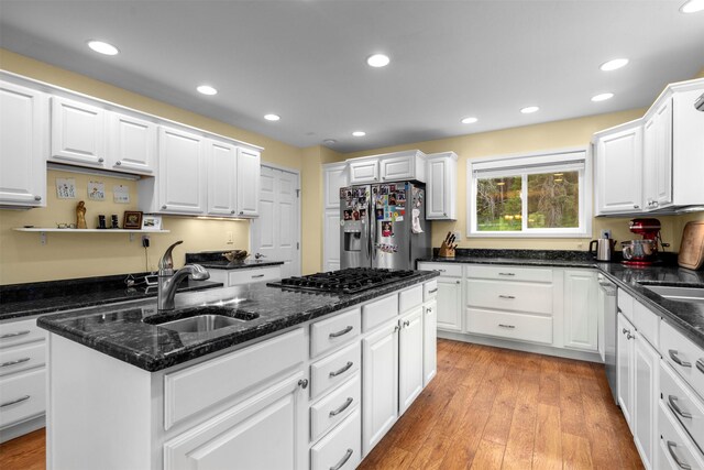 115 Wagon Wheel Rd, Whitefish, MT 59937 - kitchen with stainless steel appliances, a center island, white cabinets, recessed lighting, and dark stone countertops