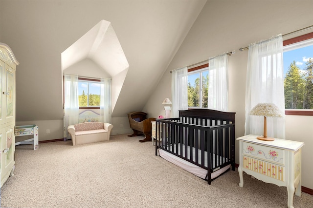 115 Wagon Wheel Rd, Whitefish, MT 59937 - bedroom with vaulted ceiling, carpet flooring, and a crib