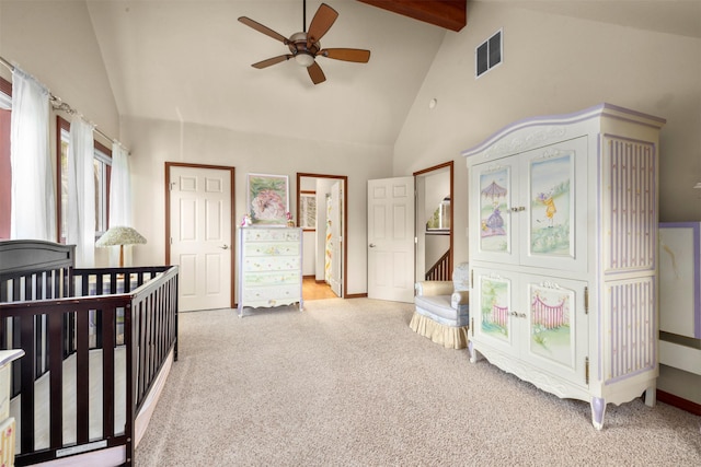 115 Wagon Wheel Rd, Whitefish, MT 59937 - bedroom with light carpet, beam ceiling, high vaulted ceiling, and a ceiling fan